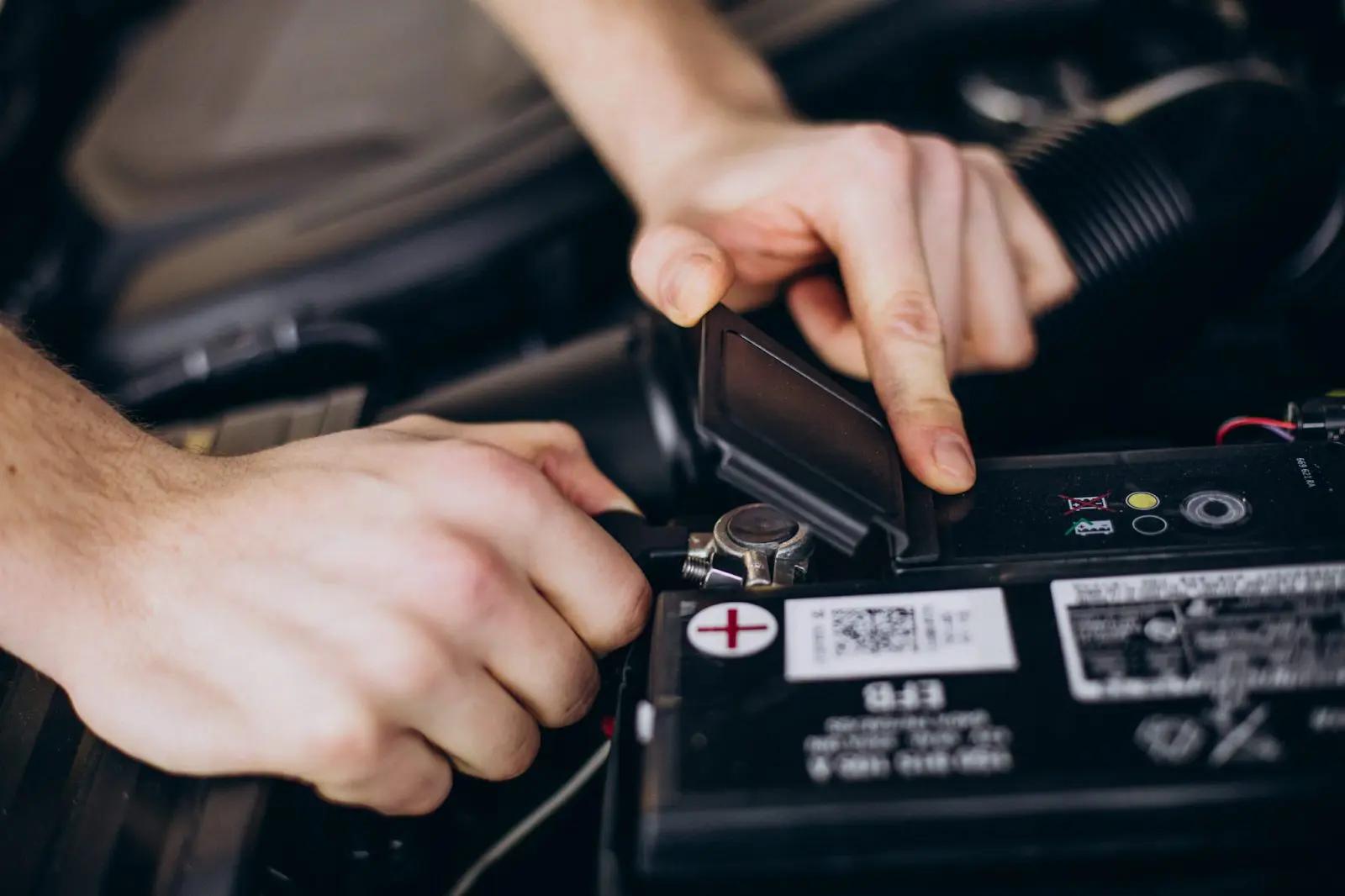 Hands connecting battery